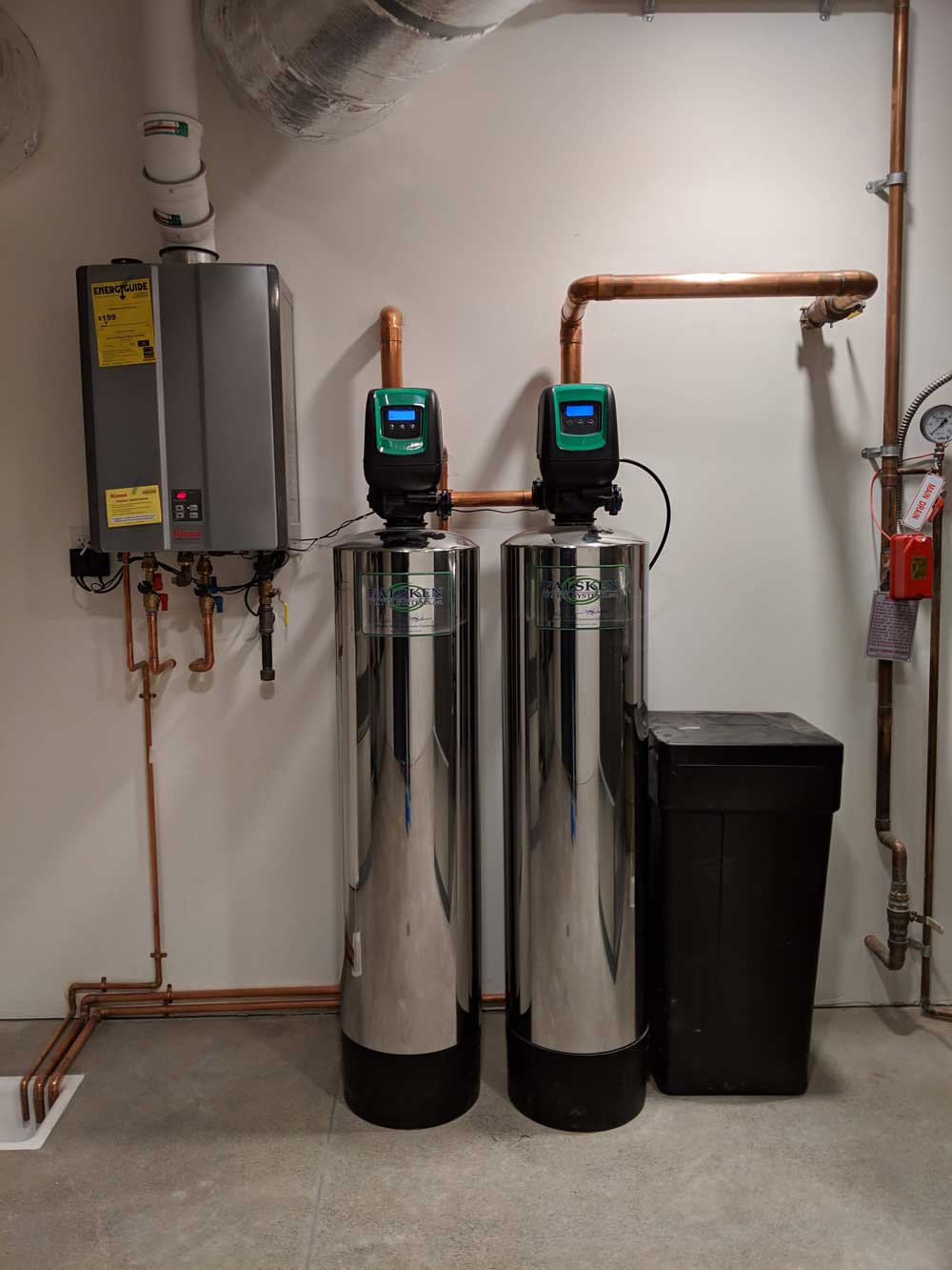 Experienced technician testing well water treatment components and checking system flow settings